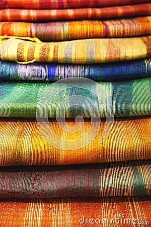 Pile of handwoven silk textiles in rainbow colors Stock Photo