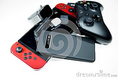 Pile of hi tech devices,console gaming, xbox controller,smartphone,addiction Editorial Stock Photo