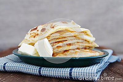 Pile of the house prepared pancakes in a green plate Stock Photo