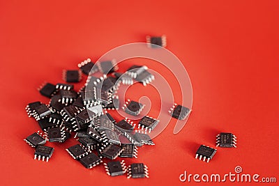 Pile of Integrated circuit chip red on background with copyspace. Microchip type soic8. Electronic components and spare part Stock Photo