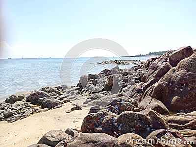 Pile Of Large Rocks On The Edge Of Tanjung Kalian Beach, Indonesia Stock Photo