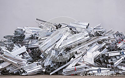 Pile of many aluminum waste construction material scraps on the ground for recycling Stock Photo