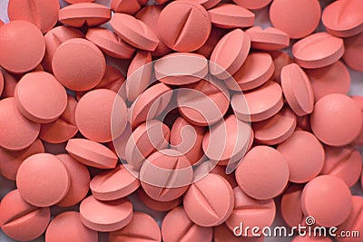 Pile of many light pink hard pills Stock Photo