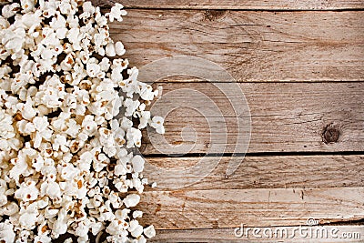 Spilled popcorn on wooden and retro desk Stock Photo