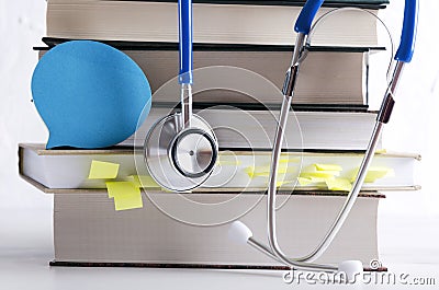 Pile of medical books, professional medical tool and paper for notes. Concept of medial training courses Stock Photo