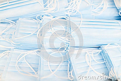 Pile of medical masks stacked and ready for shipping. Close up of blue respiratory face masks Stock Photo