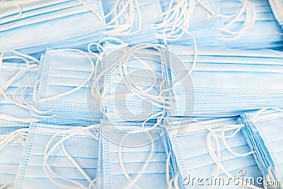 Pile of medical masks stacked and ready for shipping. Close up of blue respiratory face masks Stock Photo