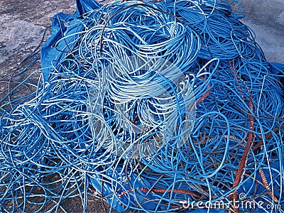 Pile of Messy Blue Tangled Electrical Cables Stock Photo