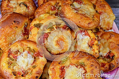 Pile of mini pizzas, Pizza is a dish of Italian origin consisting of a usually round, flat base of leavened wheat-based dough Stock Photo