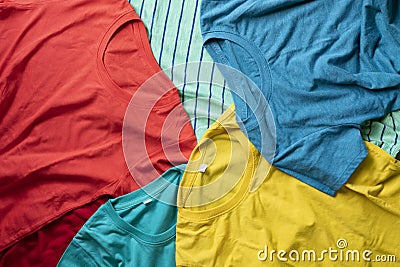 Pile of mixed dirty colorful clothes ready for washing on the black background Stock Photo