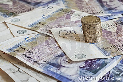 Pile of money and stacked coins british pounds sterling gbp Editorial Stock Photo