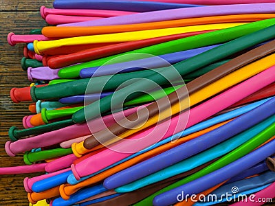 A pile of long thin multicolored modelling balloons Stock Photo