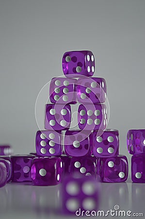 Pile of multiple purple plastic arcylic d6 six sided die dice variable focus Stock Photo