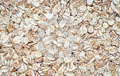 Pile of oat-flakes, background of uncooked oats. Texture of raw oatmeal. Diet food concept Stock Photo