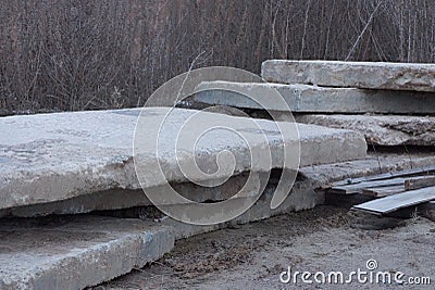 A pile of old gray industrial concrete slabs Stock Photo