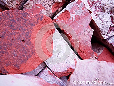 Pile of old used bricks, red bricks with plaster remnants, construction waste, broken bricks Stock Photo