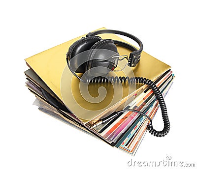 Pile of old vinyl records and vintage headphones isolated. Stock Photo