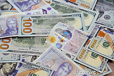 Pile of 100 $ one hundred dollar bills American cash money banknotes with Â£20 Twenty pounds cash money bill Sterling polymer Editorial Stock Photo