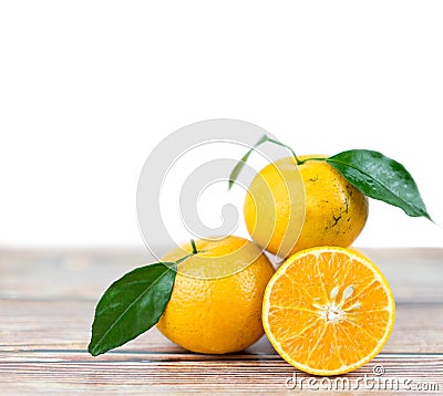 Pile Orange fruits and leaf with copy space on wooden table Stock Photo