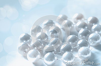 A pile of pearls on a blue and white background Stock Photo