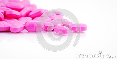 Pile of pink tablets pill isolated on white background. Norfloxacin 400 mg for treatment cystitis. Antibiotics drug resistance. Stock Photo
