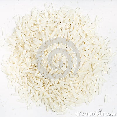 Pile of polished long-grain rice close up on gray Stock Photo