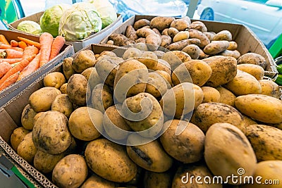 Pile potatoes in box closeup at the local market Stock Photo