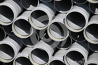 Pile of PVC tubes waiting to be installed for a sewerage system Stock Photo
