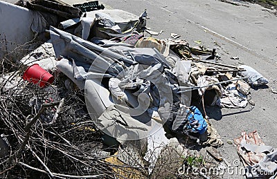 Pile of rags and garbage in a homeless camp after the forced evi Stock Photo