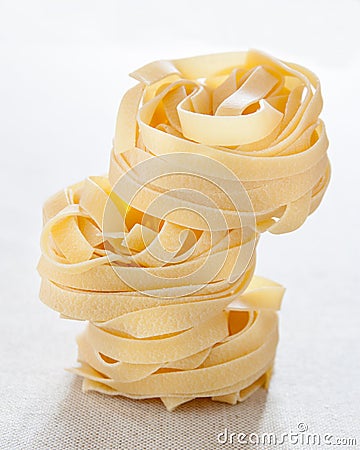 Pile of raw fettuccine nests Stock Photo