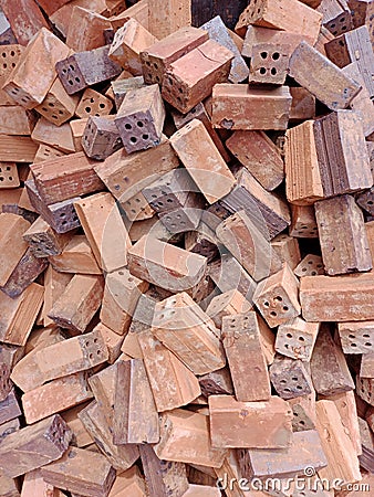 Pile of red bricks, irregular, unique, creative. Stock Photo