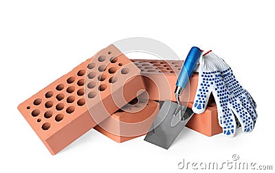 Pile of red bricks, trowel and gloves on white background Stock Photo