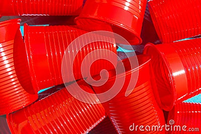 Pile of red plastic drinking cup on blue background. Environmental protection plastic-free alternatives nature friendly living Stock Photo