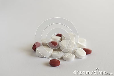 Pile of red and white pills on blue background with copy space. medicine concept Stock Photo