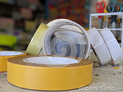 A pile of rolls of scotch tapes sellotape on a table Stock Photo