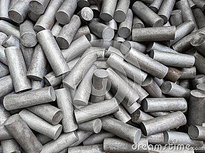 A pile of sand blasted stainless steel rods - closeup with selective focus Stock Photo