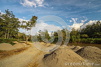 Pile of sand by the river Baliem Stock Photo