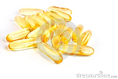 Pile of shiny yellow capsule vitamin isolated Stock Photo