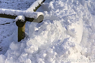 Pile of Snow at a Fence Stock Photo