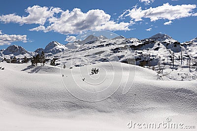 Pile of snow with high mountains, Komna plateau Stock Photo