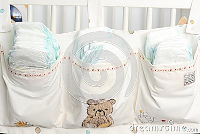 Pile or stack of diapers in baby bed hanging storage bag Stock Photo