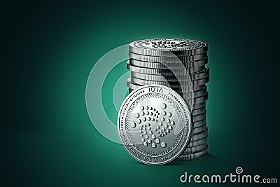 Pile or stack of silver IOTA coins on gently lit green blue background. Stock Photo