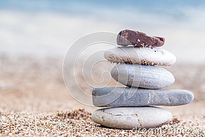 Pile of stacked stones on the sandy beach at Adriatic sea Stock Photo