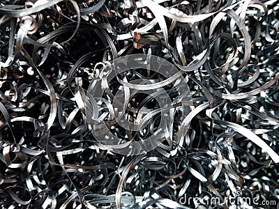 A pile of steel shavings in a metal container. Stock Photo