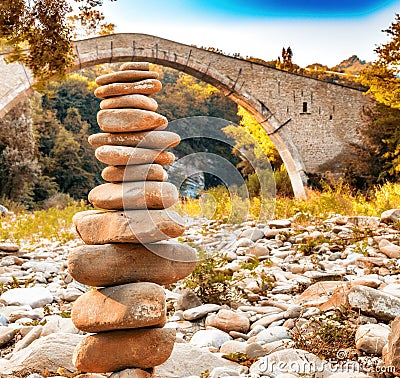 Pile of stones and hunchback bridge Stock Photo