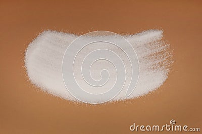 Pile of Sugar substitute Xylitol or birch sugar scattered on brown surface. Food additive E967, sweetener. Excessive consumption Stock Photo