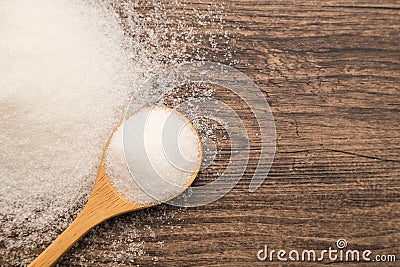 Pile of sugar on wooden plank background. Use for Diabetes check Stock Photo