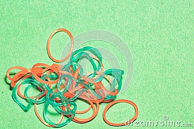 Pile thin rubber bands for hair on craft paper from above is close Stock Photo