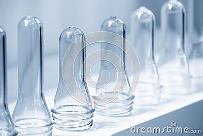 The pile of tube preform shape plastic bottles . Stock Photo