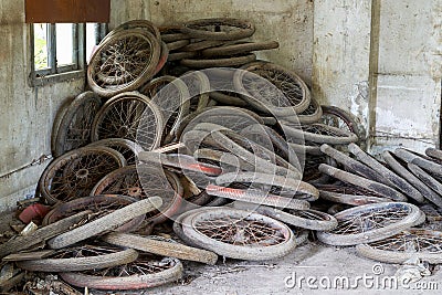 Pile of used bicycle wheels in an abandoned garbage dump Stock Photo